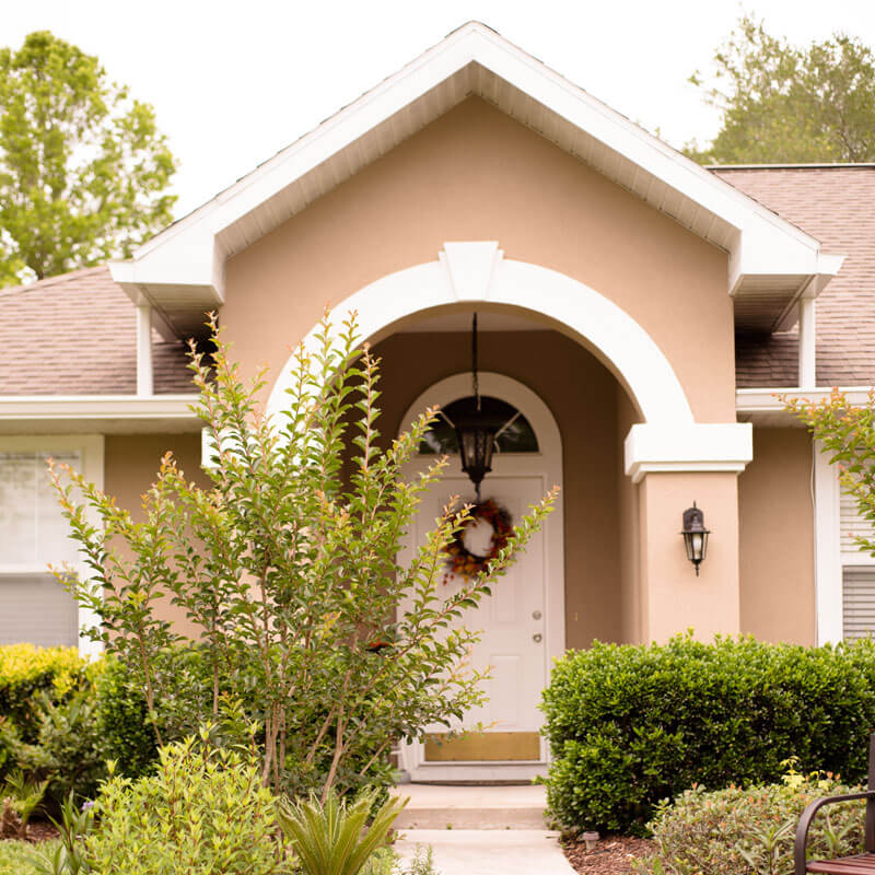 Front Door With Arc Florida Style Home. Tan Color With Tree Out