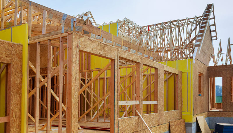 Installation Of Wooden Beams At Construction Of Frame House Photo Of A New Home Under Construction